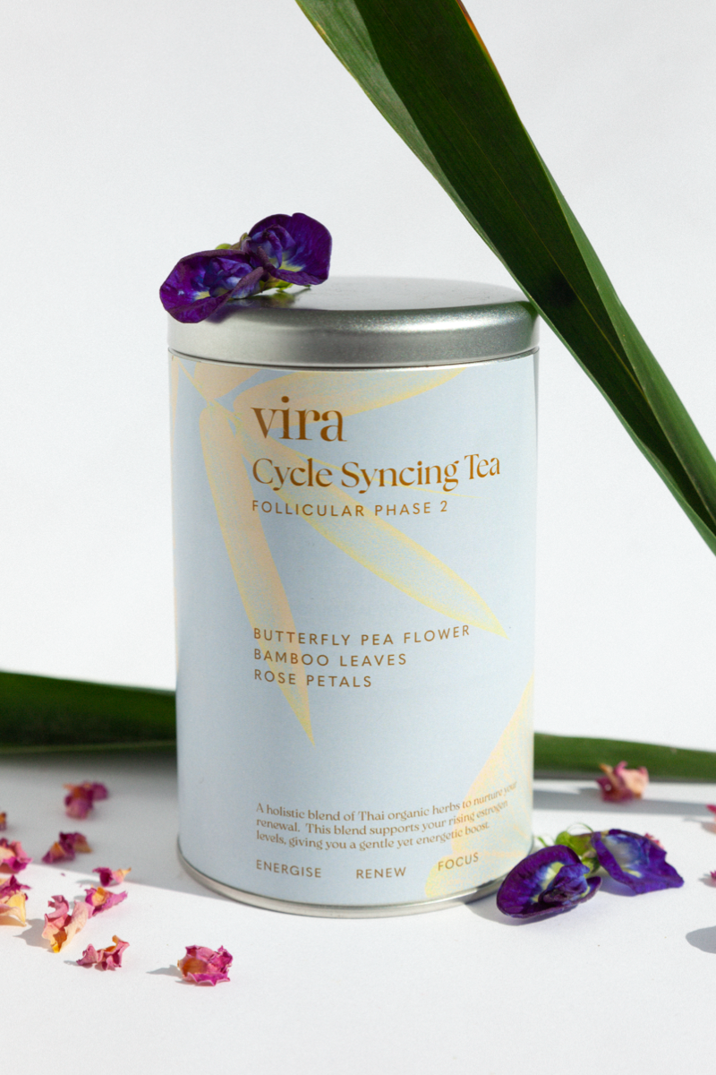 Vira Cycle Syncing Follicular Tea canister with butterfly pea flowers and a green leaf on a white background