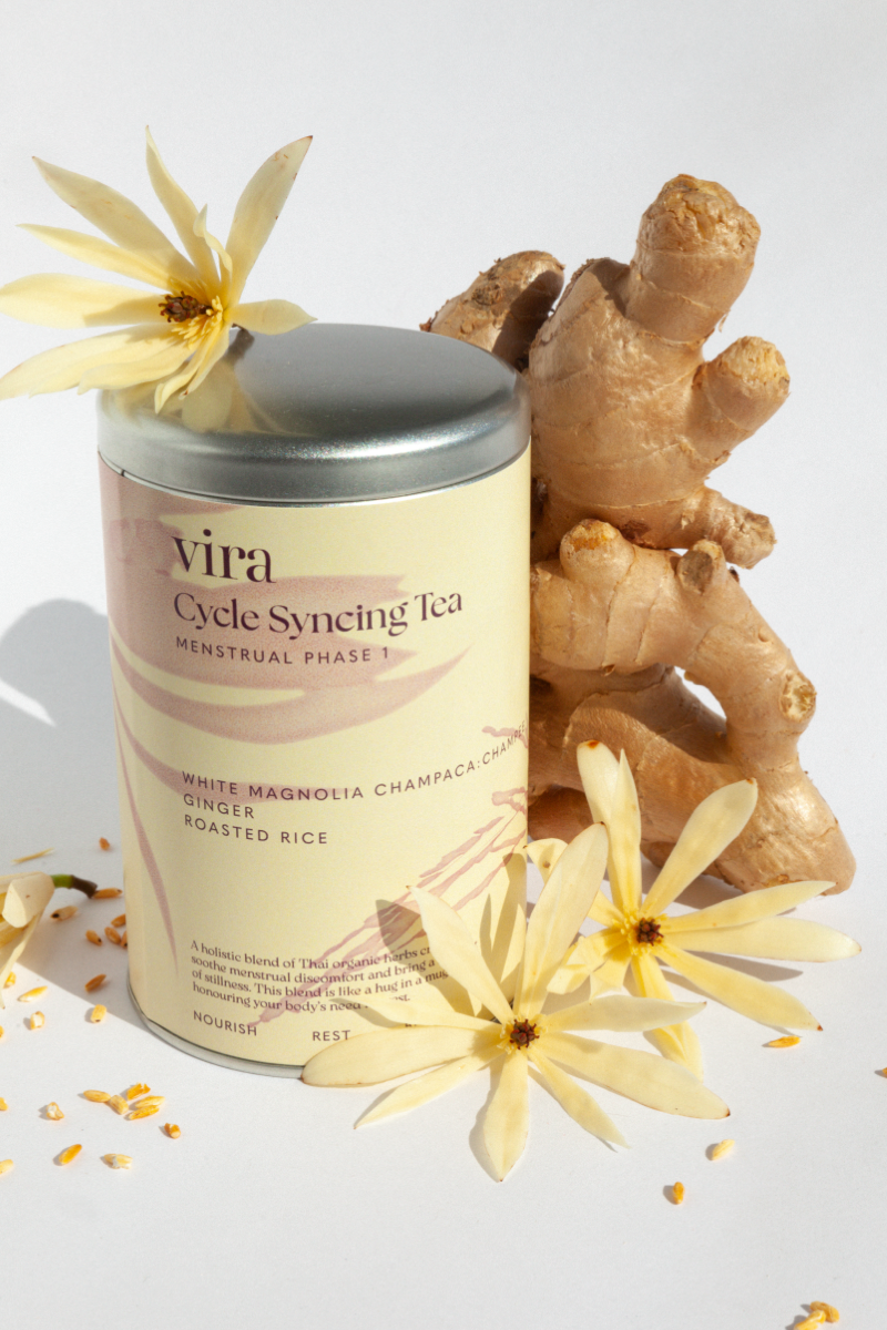 Vira Cycle Syncing Tea canister with ginger root and flowers on a light background